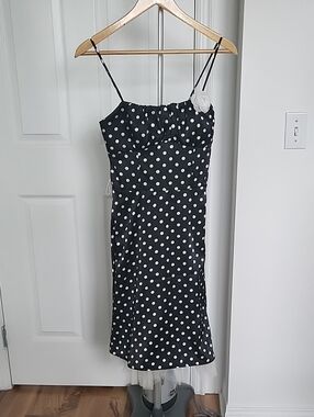 Black Polka Dot Spaghetti Strap Dress with White Flower Accent